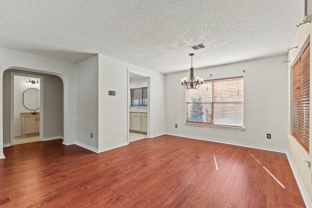 2201 Driskell Lane Corinth, TX 76210 - Photo 8 of 40 a view of empty room with wooden floor and fan