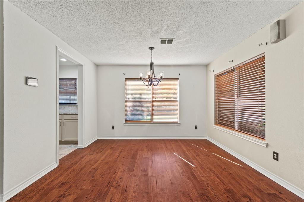 2201 Driskell Lane Corinth, TX 76210 - Photo 9 of 40 a view of an empty room with wooden floor and a window