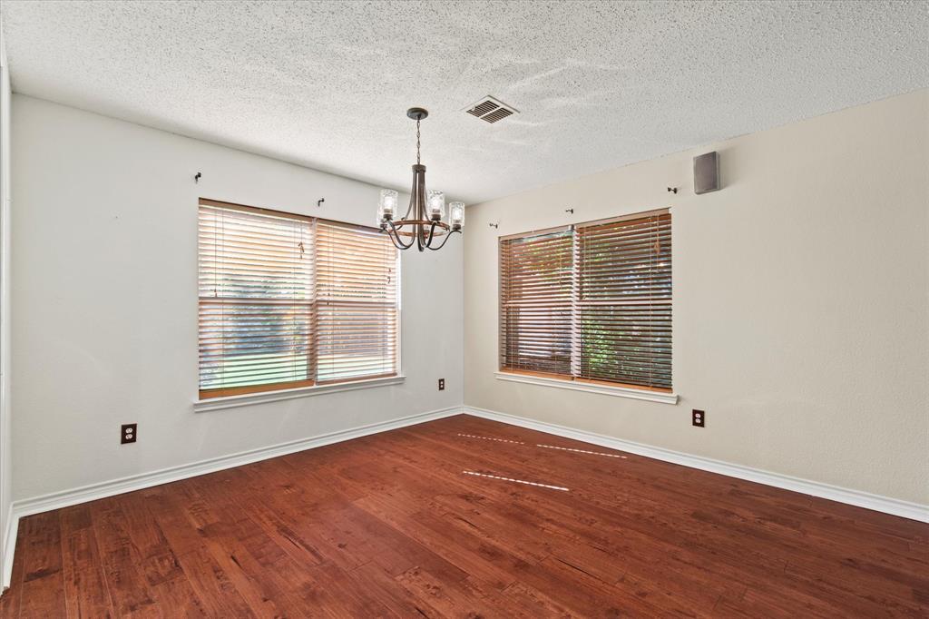 2201 Driskell Lane Corinth, TX 76210 - Photo 10 of 40 a view of an empty room with wooden floor and a window