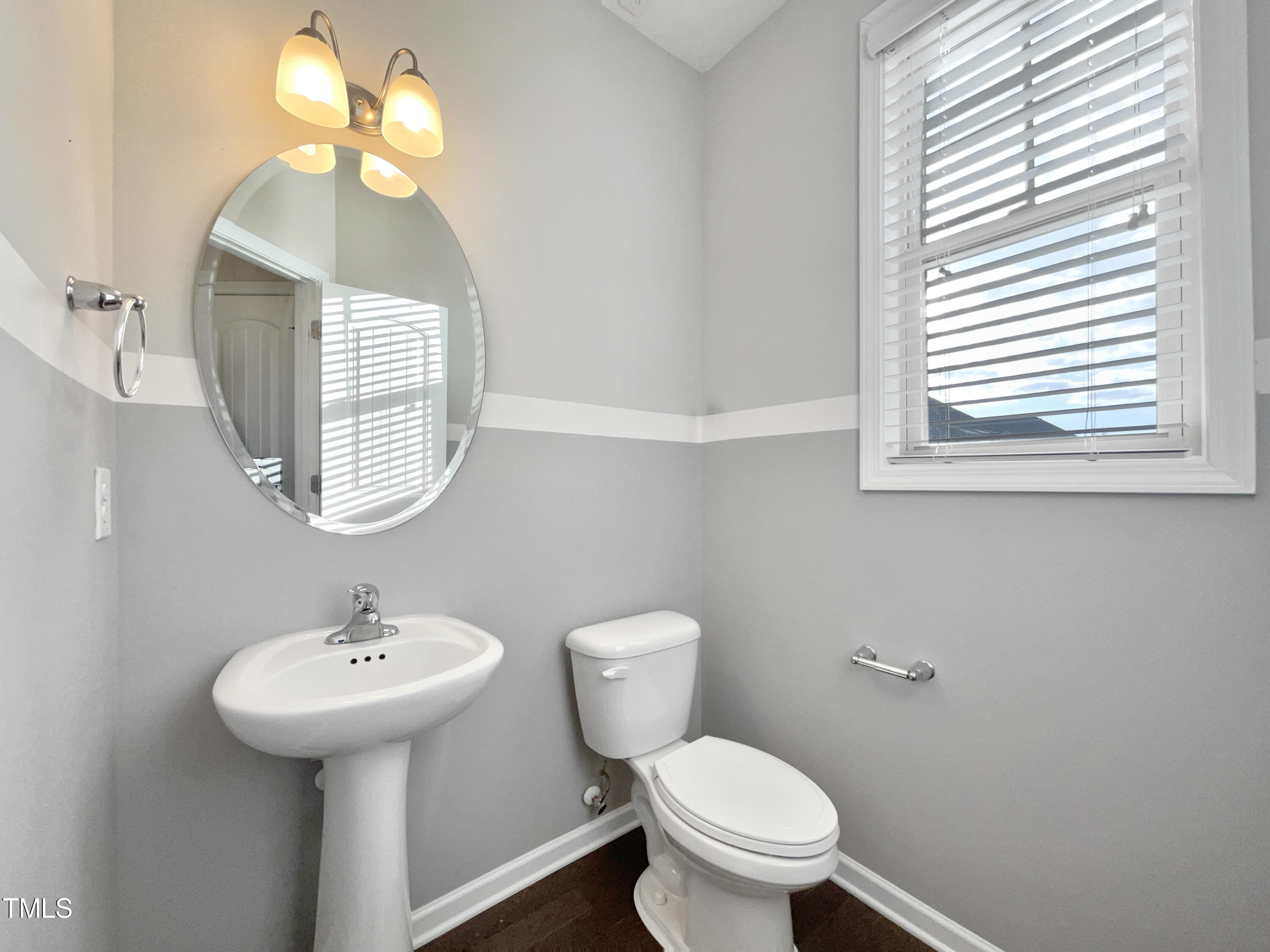 7828 Weathered Oak Way Raleigh, NC 27616 - Photo 13 of 22 a bathroom with a toilet sink and mirror