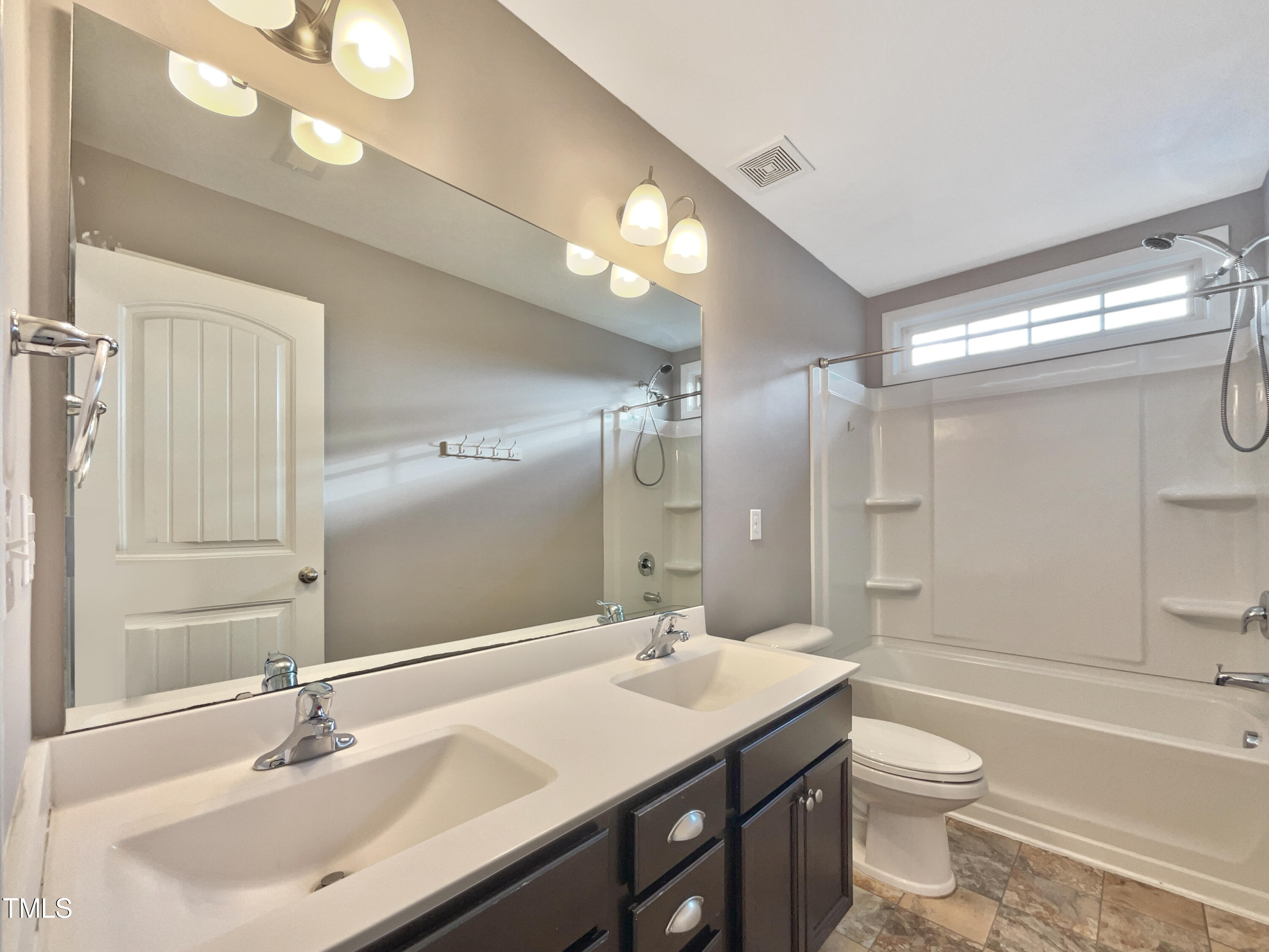 7828 Weathered Oak Way Raleigh, NC 27616 - Photo 18 of 22 a bathroom with a granite countertop sink a toilet a mirror and shower