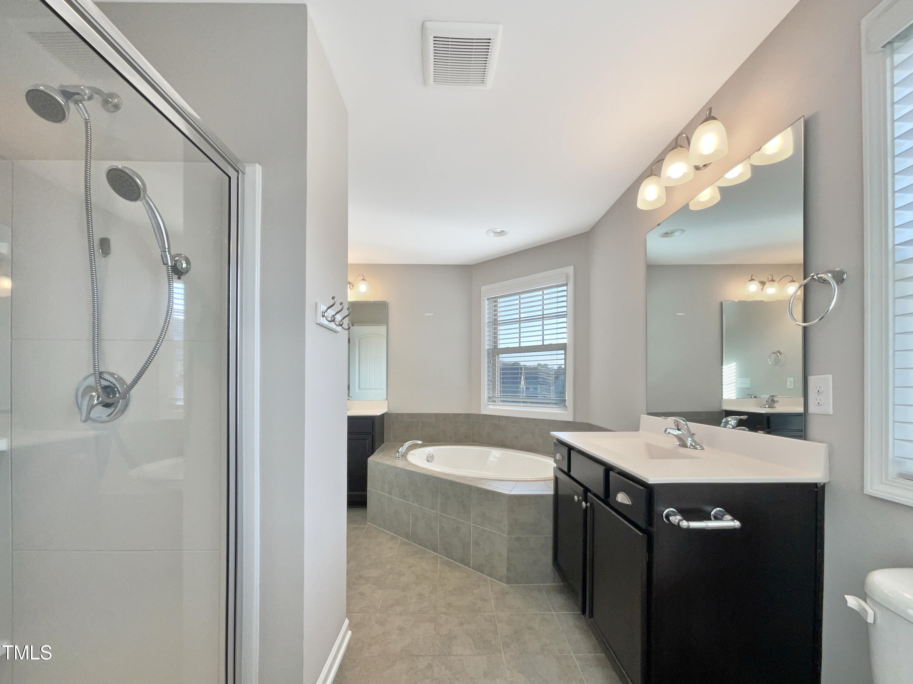 7828 Weathered Oak Way Raleigh, NC 27616 - Photo 21 of 22 a bathroom with a tub sink shower and mirror