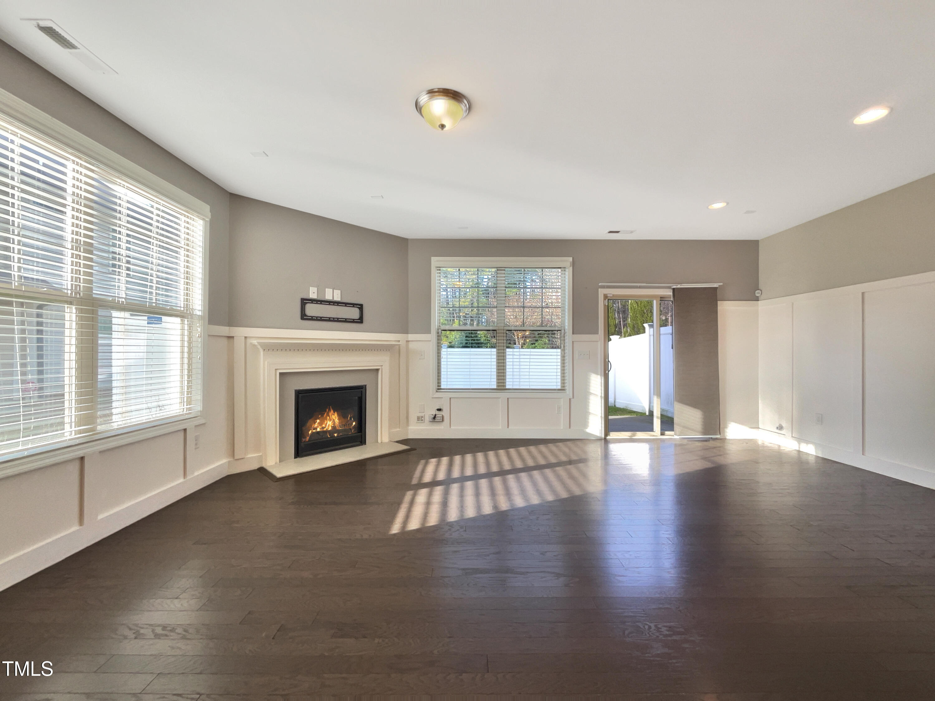 7828 Weathered Oak Way Raleigh, NC 27616 - Photo 3 of 22 a view of an empty room with wooden floor and a window