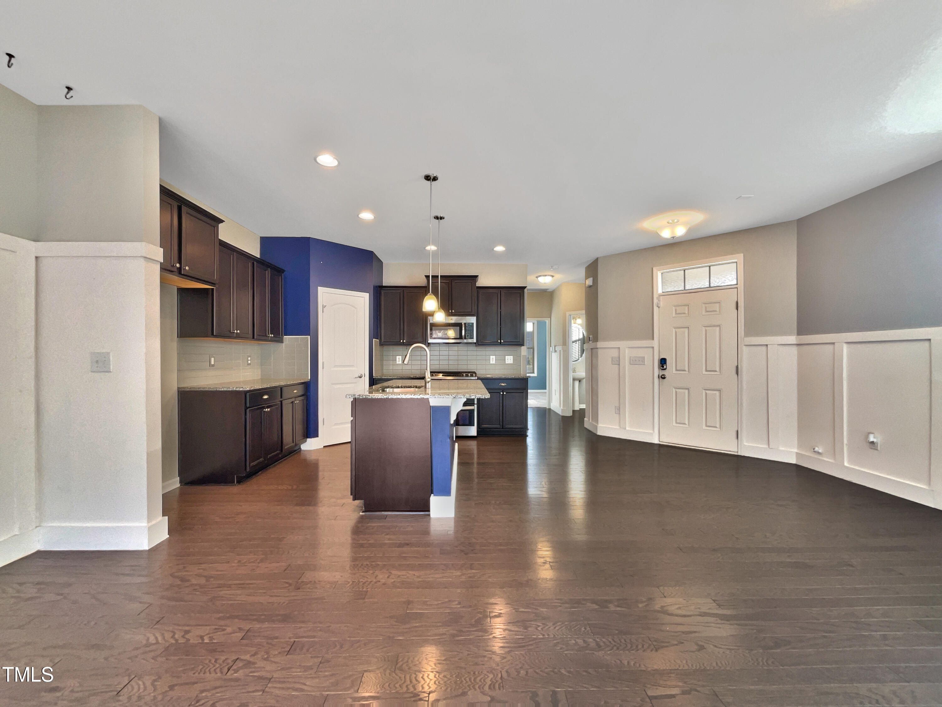 7828 Weathered Oak Way Raleigh, NC 27616 - Photo 10 of 22 a kitchen with stainless steel appliances kitchen island granite countertop a refrigerator and cabinets