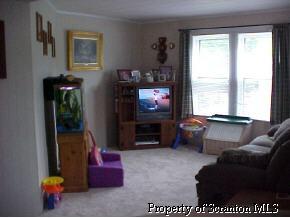 0 Rr2box2077(o Rt11) Hallstead, PA 18822 - Photo 5 of 6 a living room with furniture a flat screen tv and a floor to ceiling window