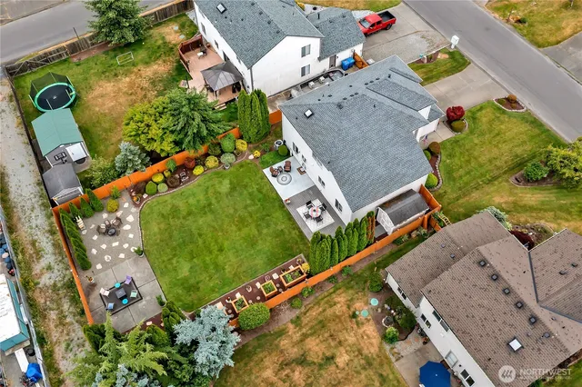 an aerial view of a house with a garden and swimming pool