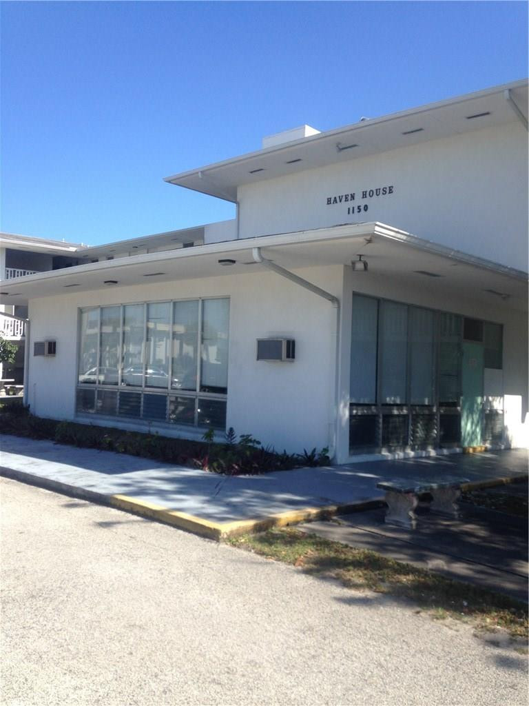 1150 East Sample Road, Unit 201 Pompano Beach, FL 33064 - Photo 1 of 8 a view of a house with a swimming pool