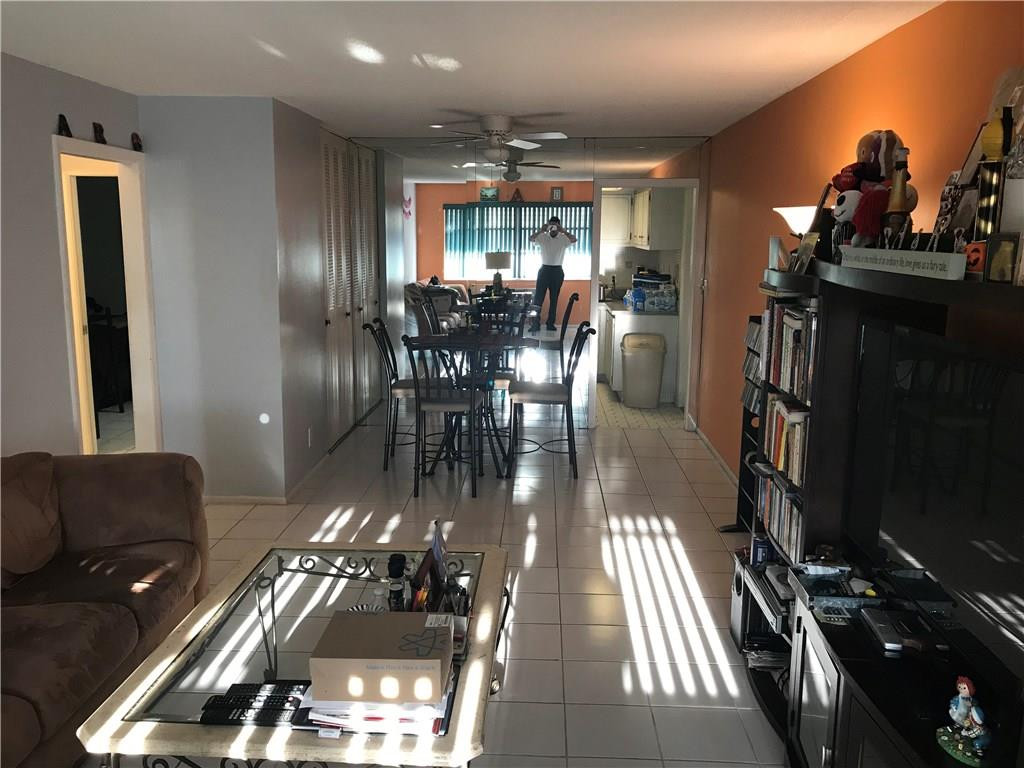1150 East Sample Road, Unit 201 Pompano Beach, FL 33064 - Photo 2 of 8 a view of a room with gym equipment