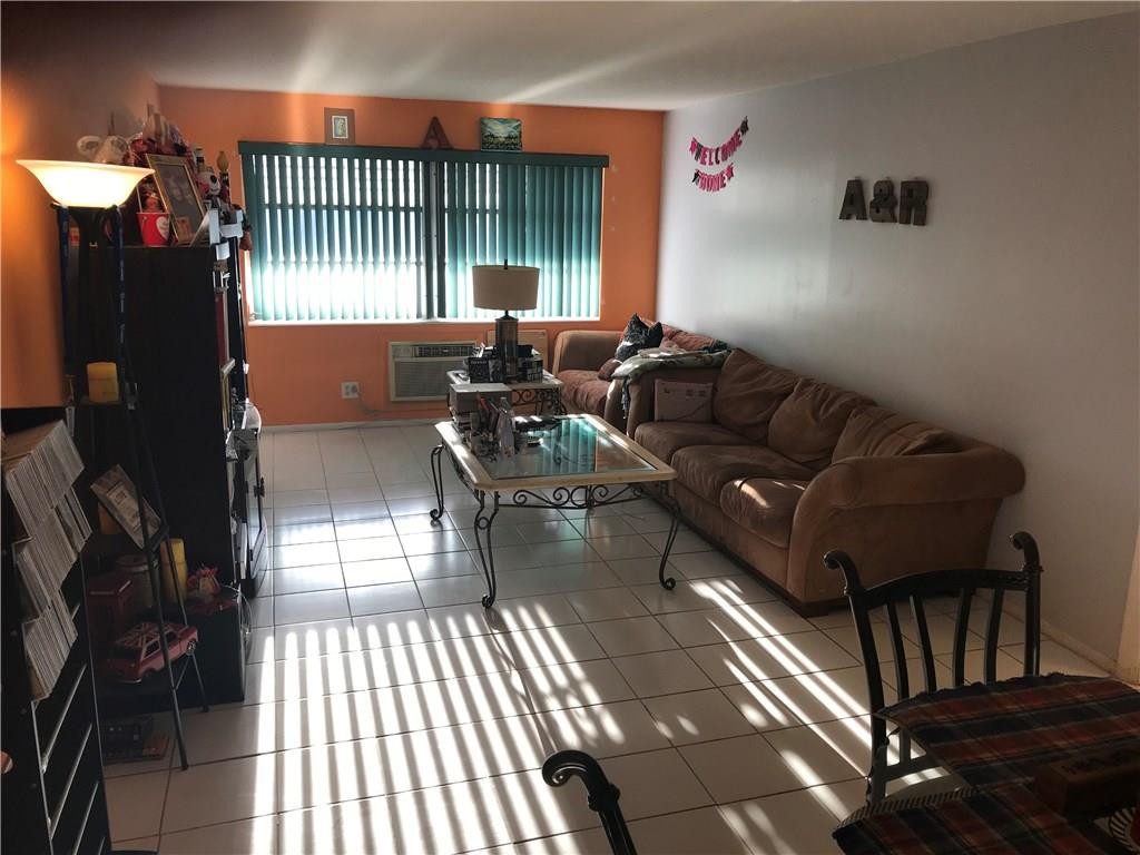 1150 East Sample Road, Unit 201 Pompano Beach, FL 33064 - Photo 4 of 8 a living room with furniture