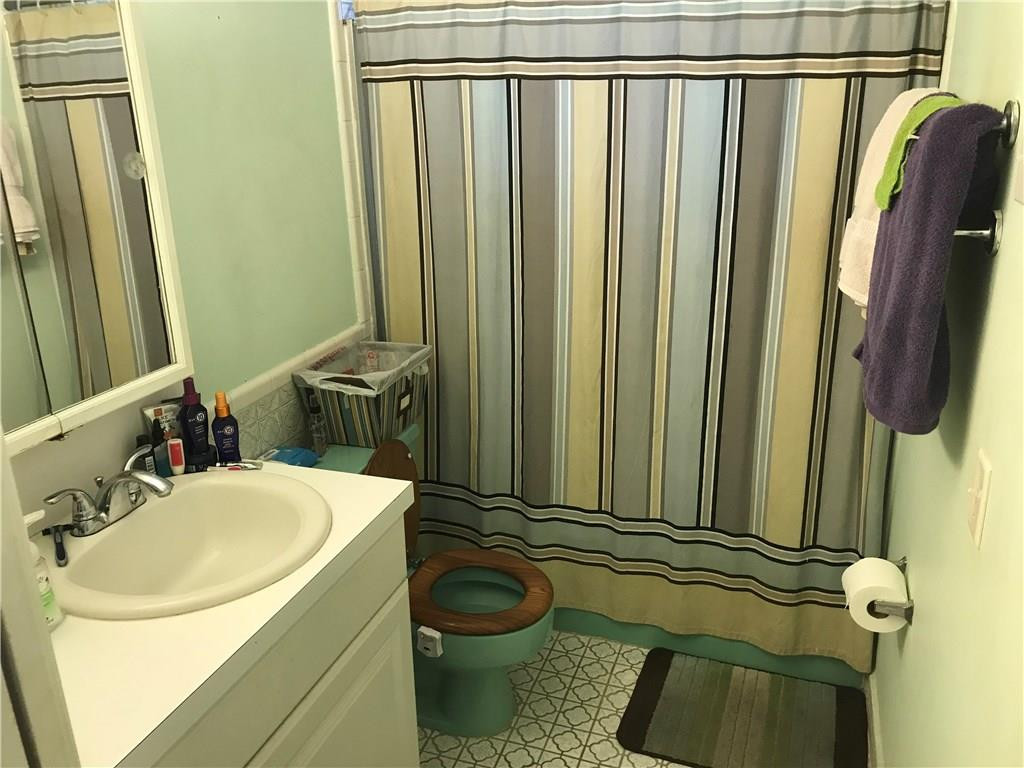 1150 East Sample Road, Unit 201 Pompano Beach, FL 33064 - Photo 8 of 8 a bathroom with a sink a toilet and tub