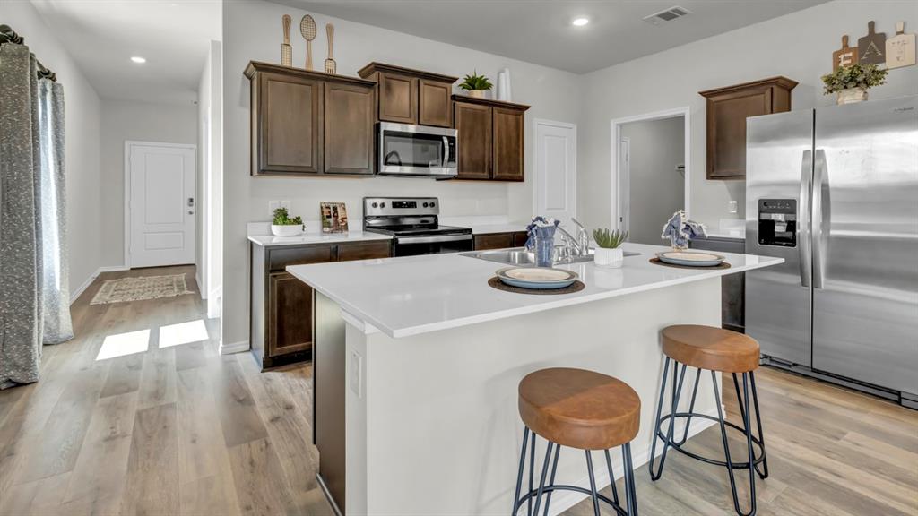 124 Pheasant Run Road Terrell, TX 75160 - Photo 20 of 35 Open-concept kitchen with a central island featuring a white countertop