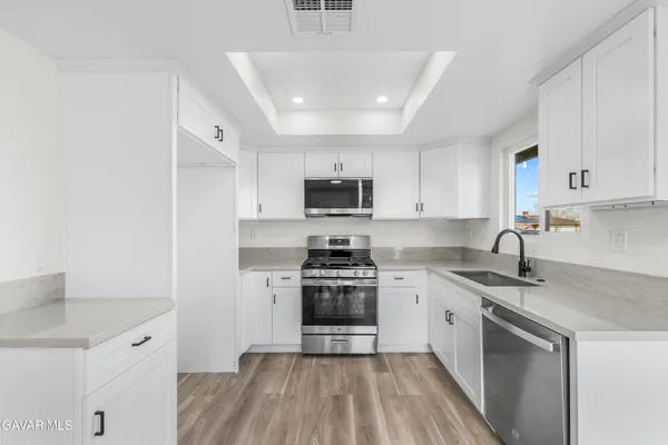 a kitchen with a sink stove and refrigerator