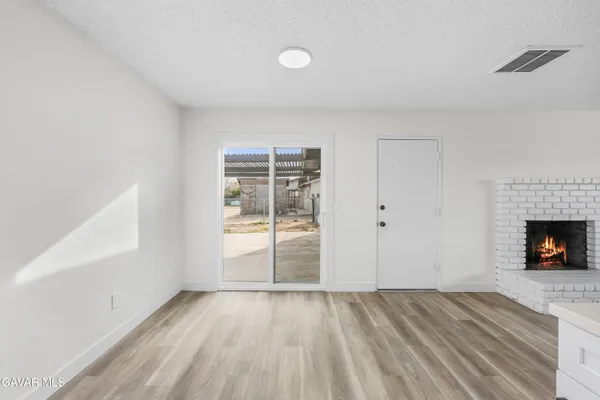 wooden floor in an empty room with a fireplace