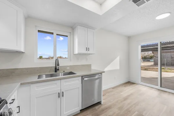 a kitchen with granite countertop a sink and cabinets