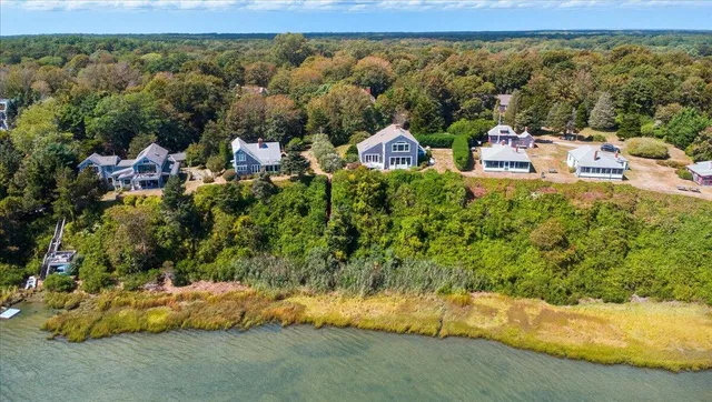 a living room with furniture and floor to ceiling windows