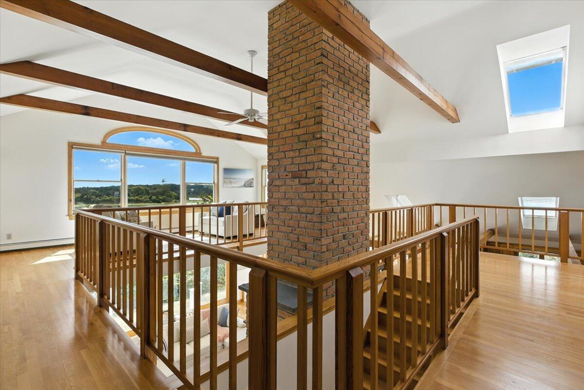 60 Smith Heights Way Eastham, MA 02642 - Photo 18 of 70 a view of staircase with railing and a floor to ceiling window