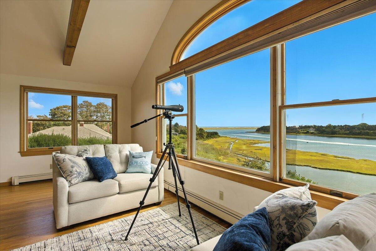 60 Smith Heights Way Eastham, MA 02642 - Photo 20 of 70 a living room with furniture and floor to ceiling windows