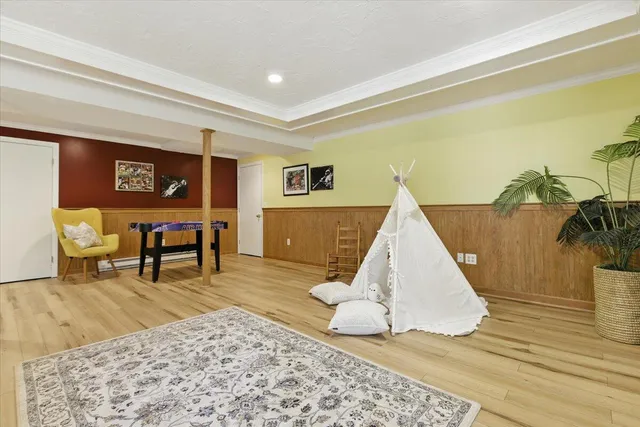 a kitchen with stainless steel appliances kitchen island granite countertop a refrigerator a stove and a sink with wooden floor