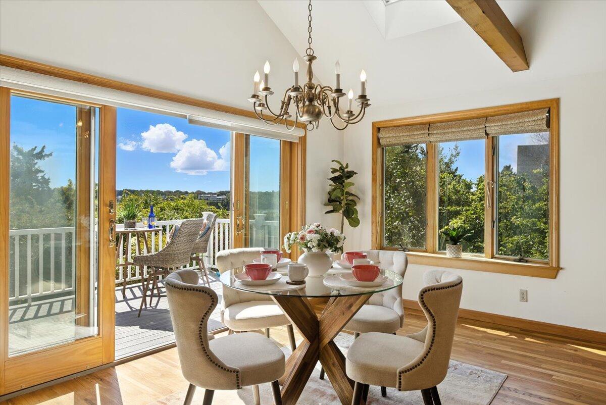 60 Smith Heights Way Eastham, MA 02642 - Photo 44 of 70 a view of a dining room with furniture large windows and wooden floor
