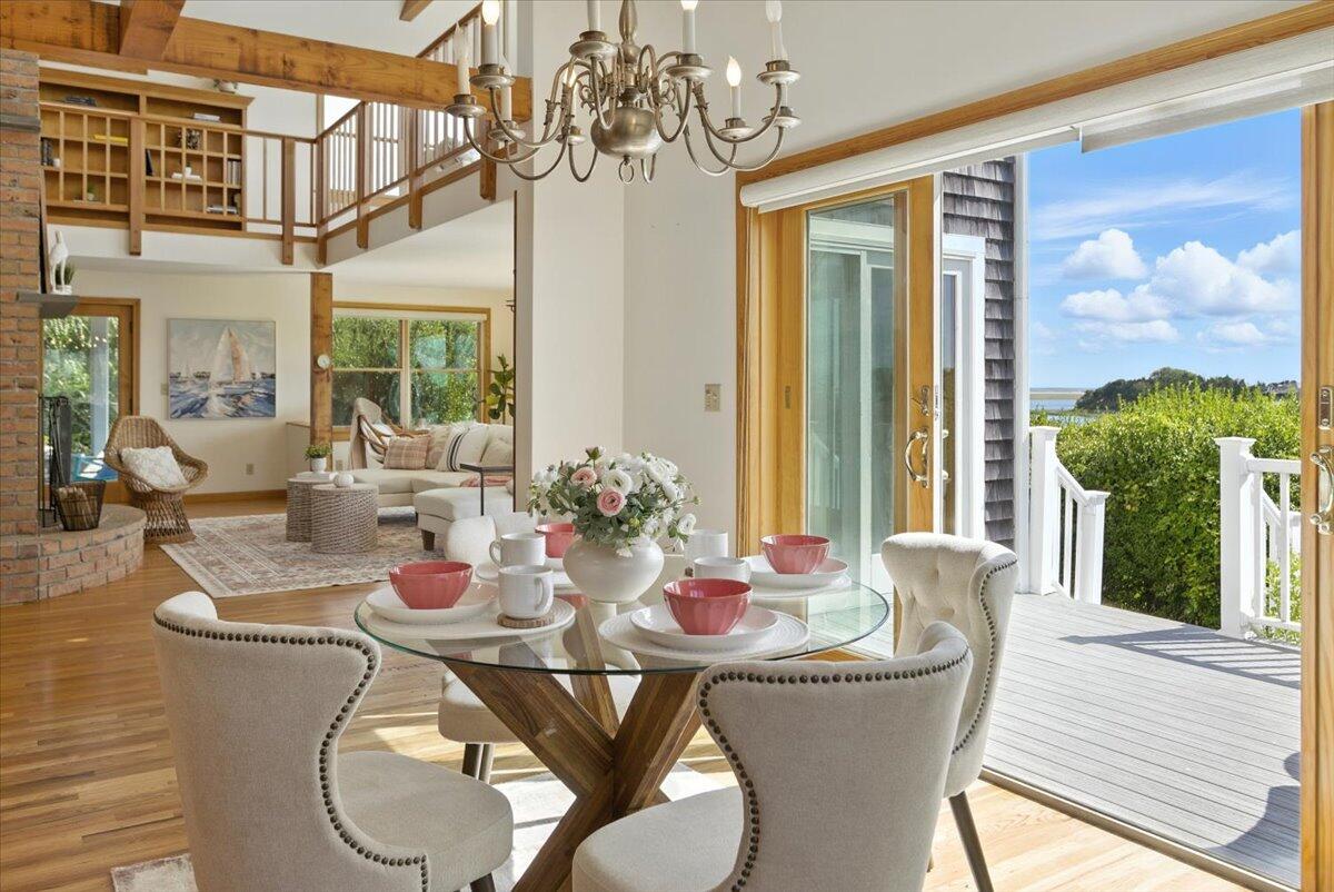 60 Smith Heights Way Eastham, MA 02642 - Photo 46 of 70 a view of a dining room with furniture a chandelier and wooden floor