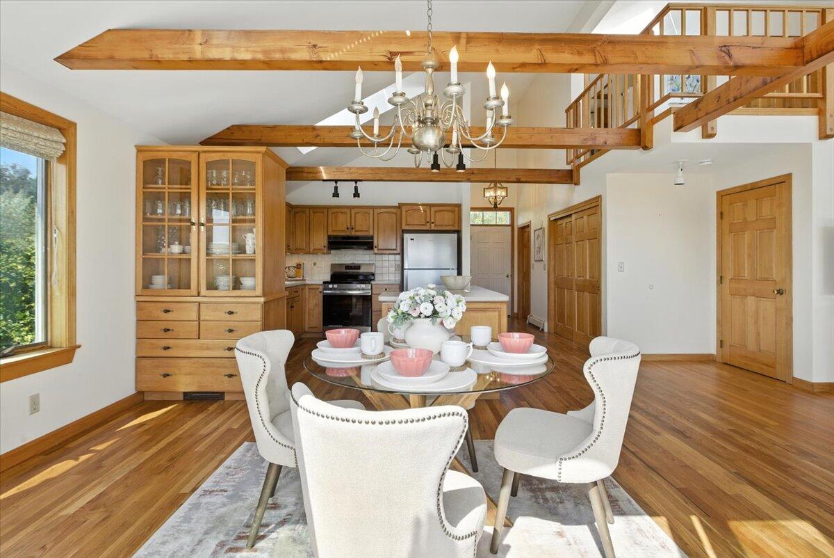 60 Smith Heights Way Eastham, MA 02642 - Photo 48 of 70 a dining room with furniture a chandelier and wooden floor