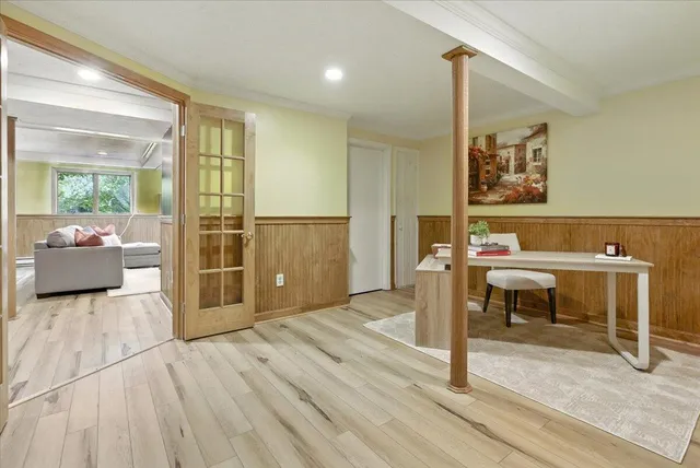 a dining room with furniture a chandelier and wooden floor