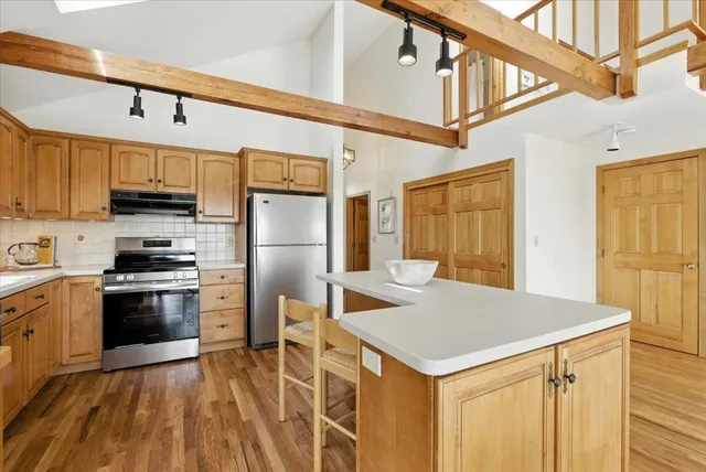 a kitchen with a refrigerator stove and sink
