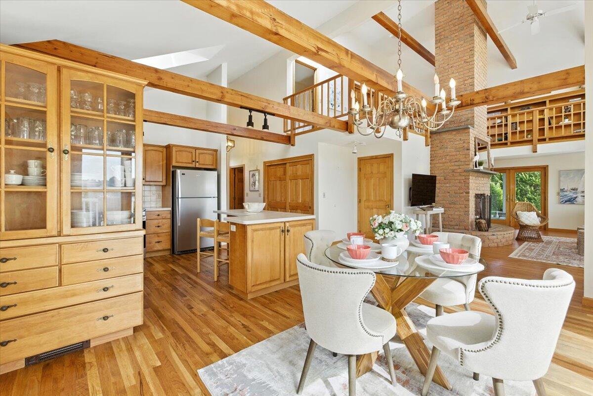 60 Smith Heights Way Eastham, MA 02642 - Photo 51 of 70 a view of a dining room with furniture a chandelier and wooden floor