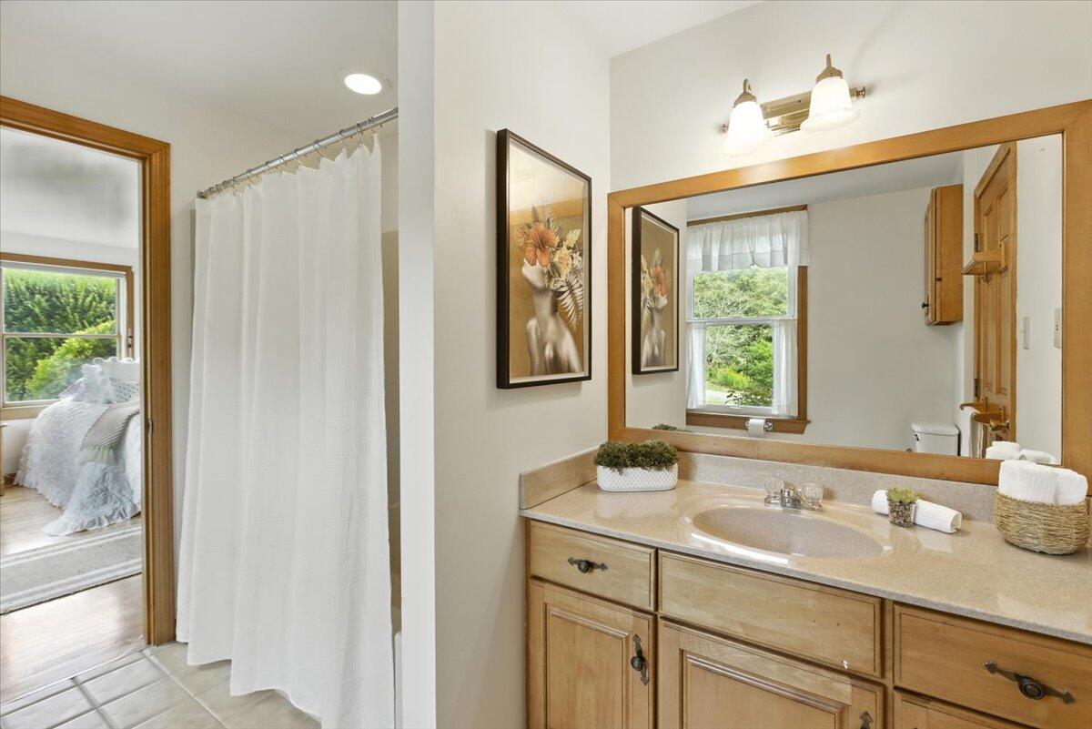 60 Smith Heights Way Eastham, MA 02642 - Photo 53 of 70 a bathroom with a granite countertop sink and a mirror