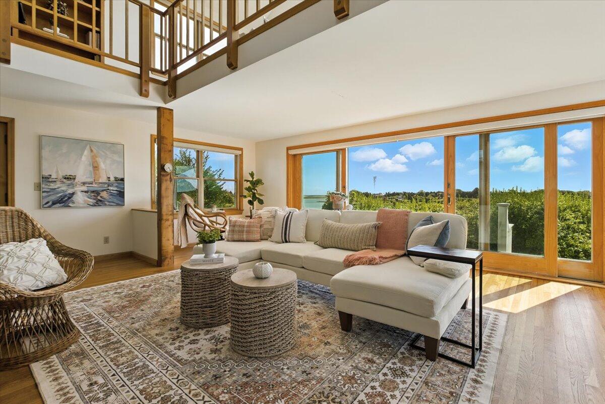 60 Smith Heights Way Eastham, MA 02642 - Photo 64 of 70 a living room with furniture and a floor to ceiling window