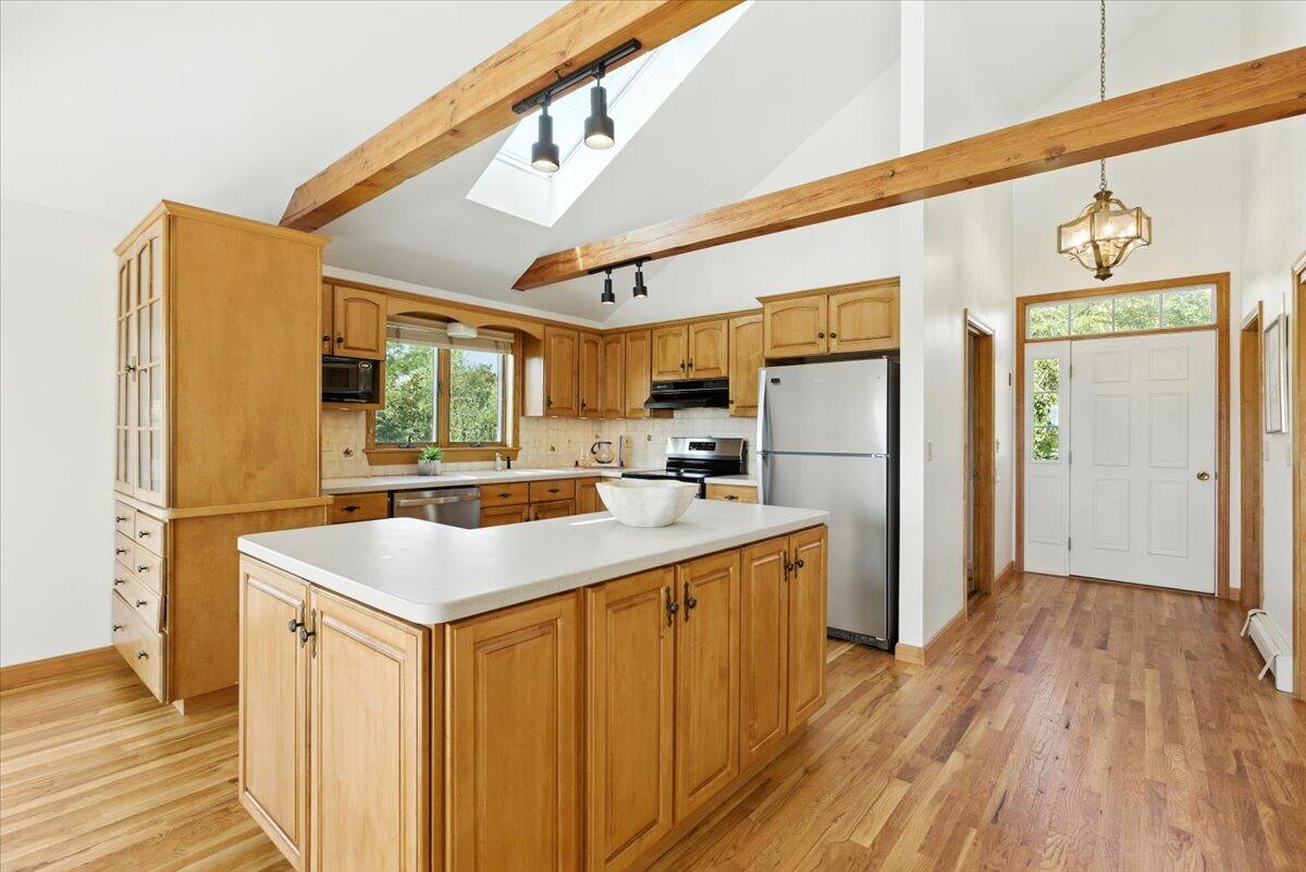 60 Smith Heights Way Eastham, MA 02642 - Photo 66 of 70 a kitchen with a sink a refrigerator a stove and a wooden floor