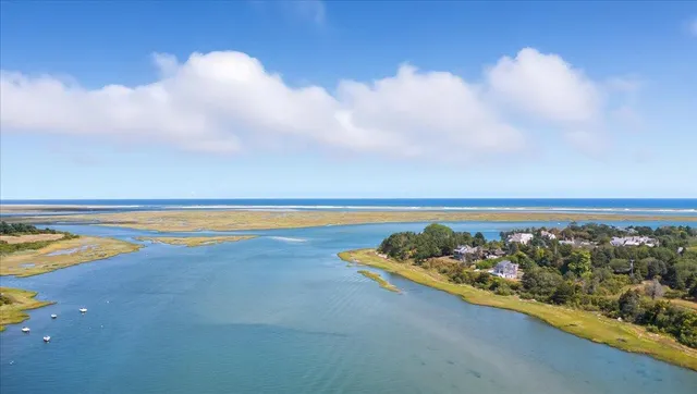 an aerial view of a house with a yard