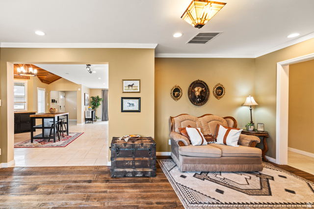 460 Omni Point Road Central Valley, UT 84754 - Photo 24 of 101 Warm interior space featuring wood-finish flooring, light tan wall color, and white crown molding