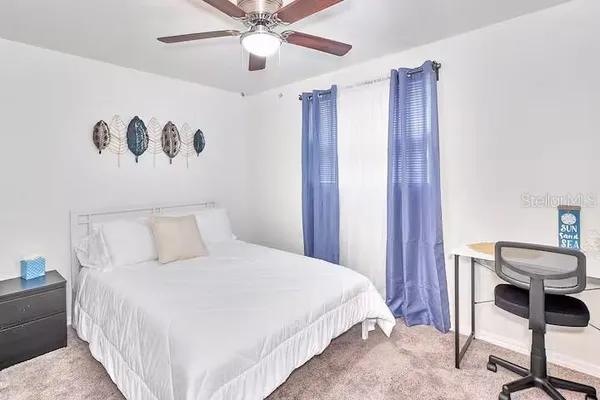 a bedroom with a bed couch and a window
