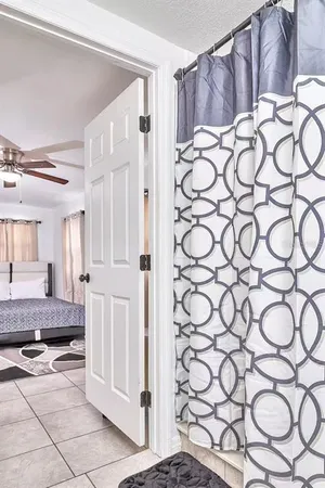 a bedroom with a large bed and a ceiling fan