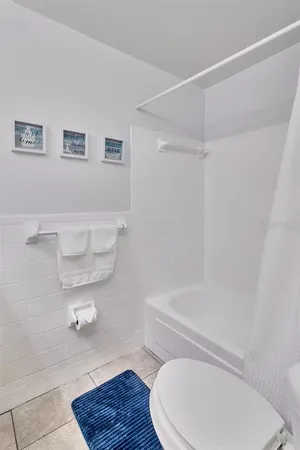 a bedroom with a bed and a ceiling fan