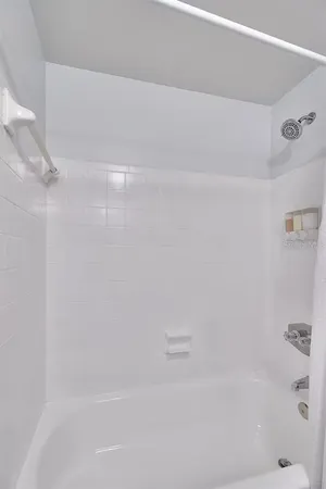 a bedroom with a large bed and a flat screen tv