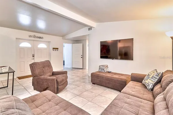 a living room with furniture and a flat screen tv