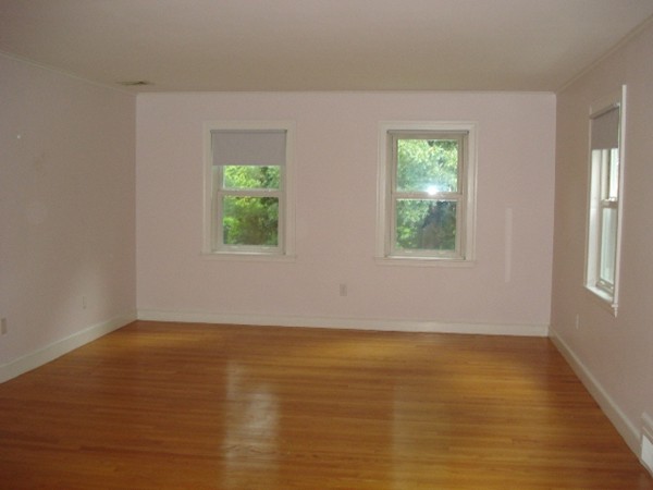 116 Edmunds Road Wellesley, MA 02481 - Photo 10 of 14 a view of an empty room with wooden floor and a window