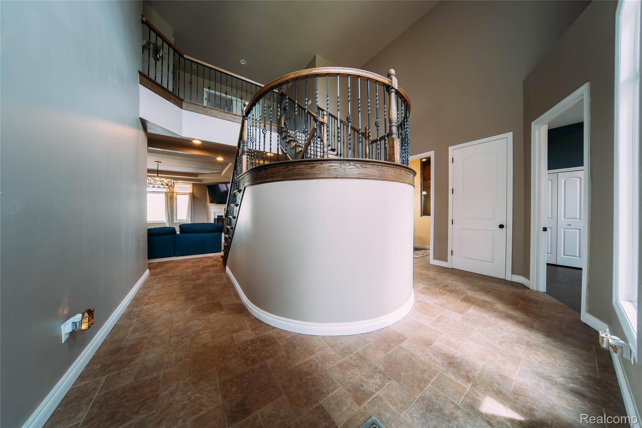 67102 Rachael Lane Washington, MI 48095 - Photo 10 of 37 Corridor with a high ceiling, stone finish flooring, and a chandelier