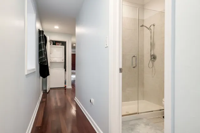 a bathroom with a shower and a glass door
