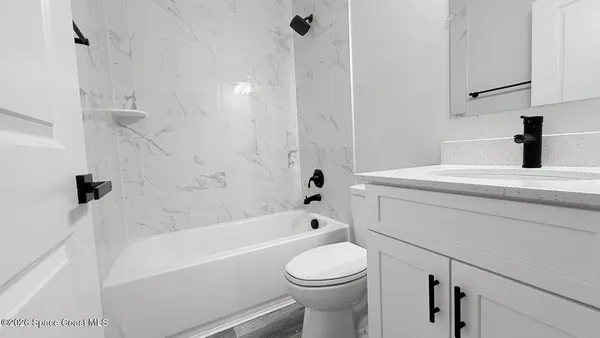 a bathroom with a sink a toilet and a bathtub