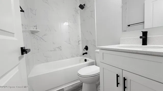 a bathroom with a sink a toilet and a bathtub