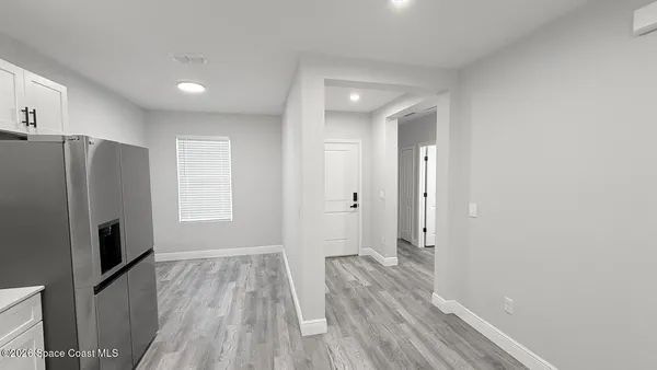 a view of a hardwood floor in a kitchen