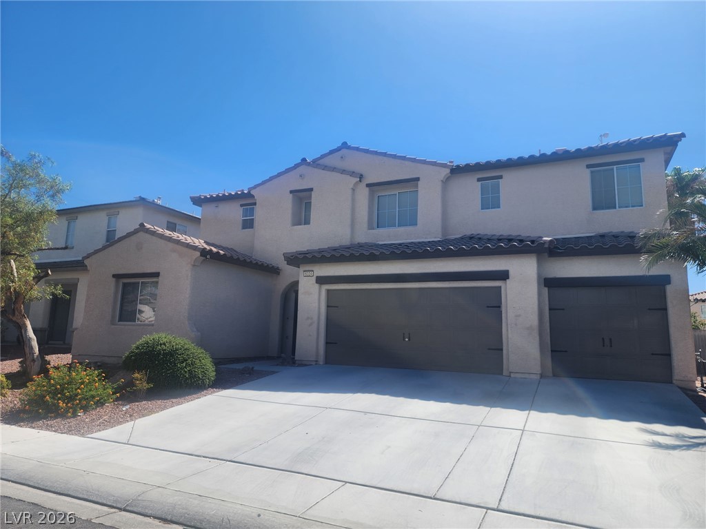 6324 Sterling Ranch Way North Las Vegas, NV 89081 - Photo 2 of 2 A well-maintained stucco exterior and concrete driveway enhance this charming two-story residence.