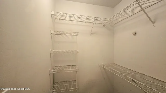 a bathroom with a granite countertop sink toilet a mirror and shower curtain