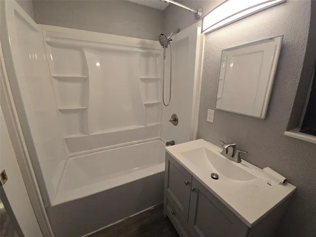 a bathroom with a sink a shower and a mirror