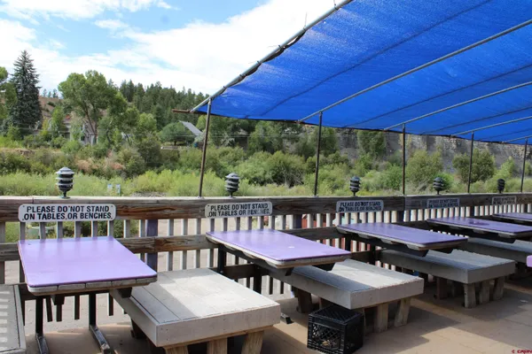 a view of a patio with chairs a barbeque