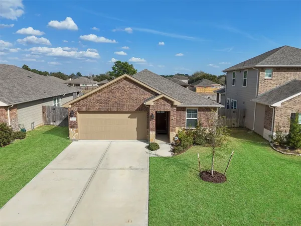 a front view of house with a garden and yard