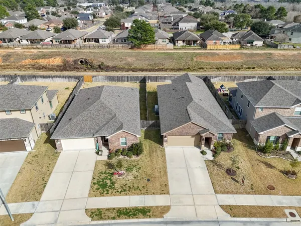 an aerial view of residential houses with outdoor space